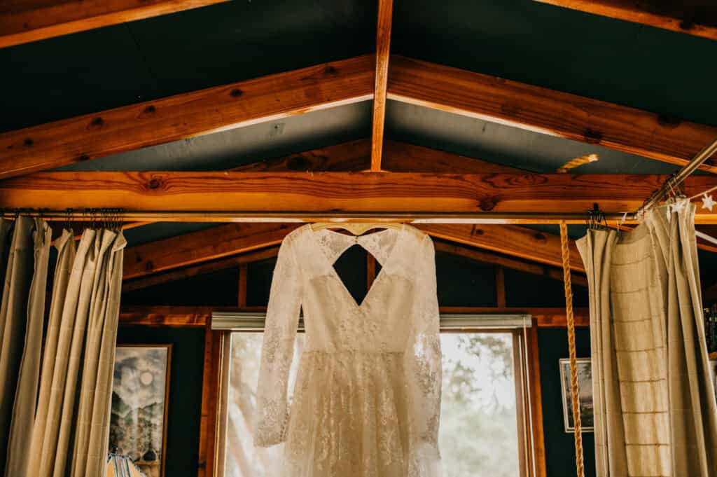 a wedding dress hanging from the ceiling