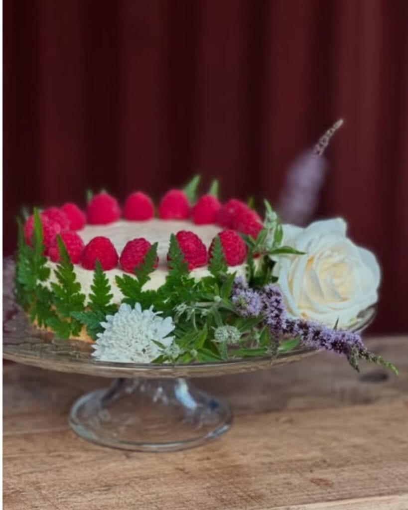 wedding cake with flowers and raspberries