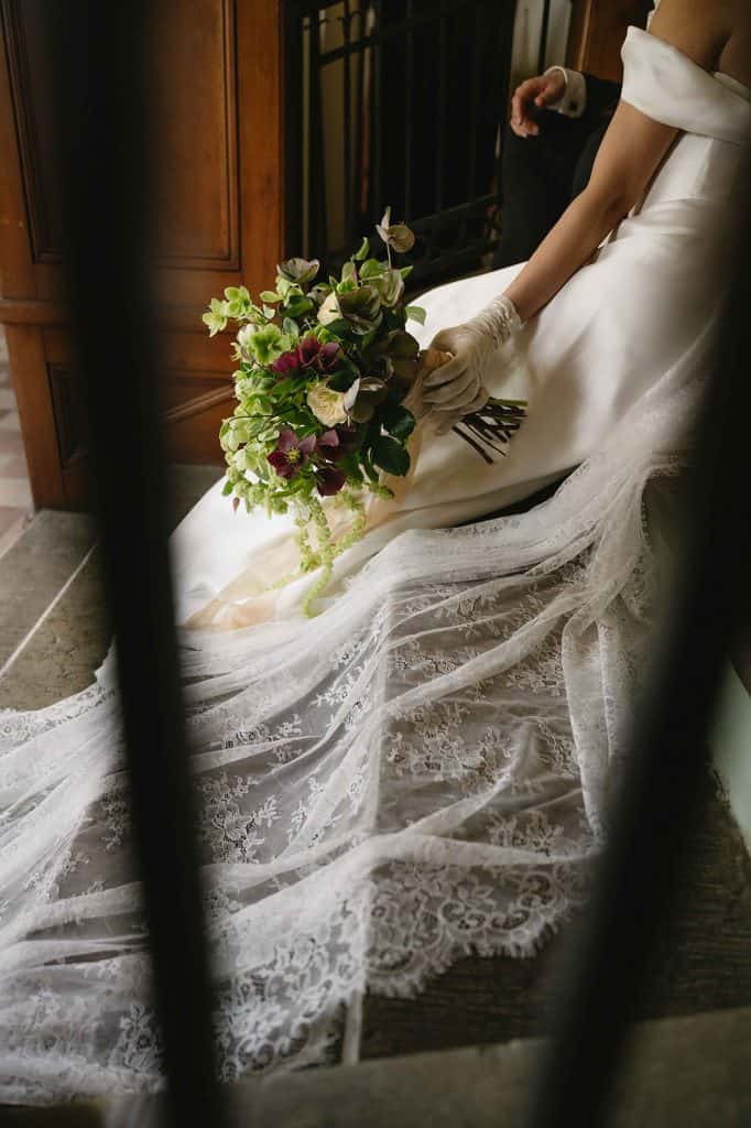 Close up of a wedding bouquet with the wedding dress